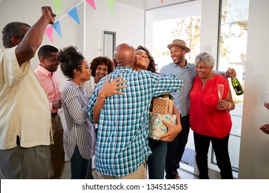 Black Grandparents Welcoming Guests To Their House For A Family Party