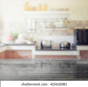 Black Granite Table Top And Blur Of Modern Kitchen Interior As Background