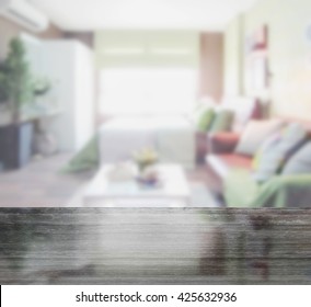 Black Granite Table Top And Blur Of Colorful Bedroom With Sofa