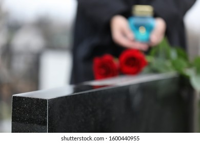 Black Granite Tombstone Outdoors, Closeup. Funeral Ceremony