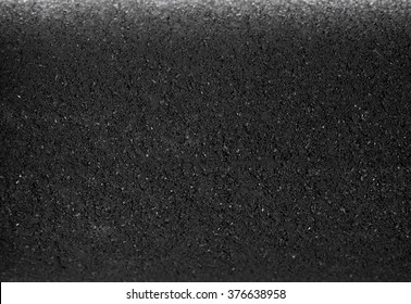 Black granular activated carbon Compaction texture background. Selective focus.