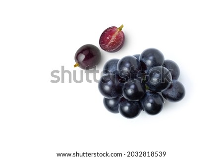 Black grapes fruit and half sliced isolated on white background. Top view. Flat lay. 