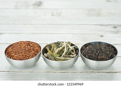 Black, Green, And Rooibos Tea Leaves, Wooden Table Background