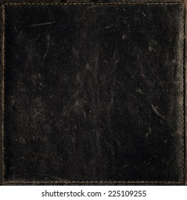 Black grunge background from distress leather texture 