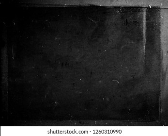 Black grunge scratched scary background with frame, distressed chalkboard, old film effect, copy space