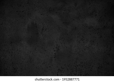 Black grunge texture background. Close-up on cement wall surface, with bw low key treatment.