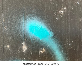 Black grungy street panel with turquoise spray paint swoosh 