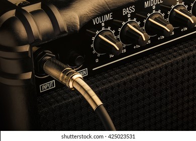 Black Guitar Amplifier with jack plugged in. Close up macro. - Powered by Shutterstock