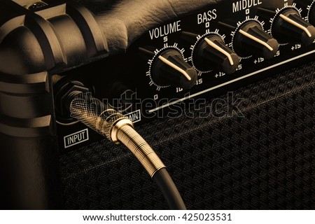 Black Guitar Amplifier with jack plugged in. Close up macro.