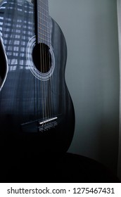 Black Guitar in Window Light Reflection