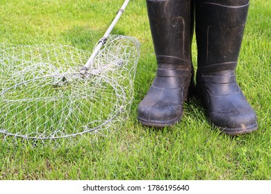 Black Gumboots And Landing Net