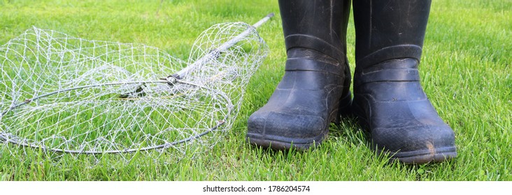 Black Gumboots And Landing Net