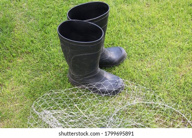 Black Gumboots And Landing Net