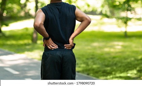 Black Guy Having Back Pain During His Morning Run At Park, Copy Space. Panorama