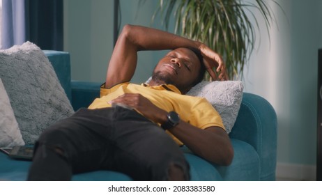 Black guy sleeping on sofa