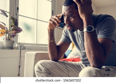 Black guy talking phone with angry emotion