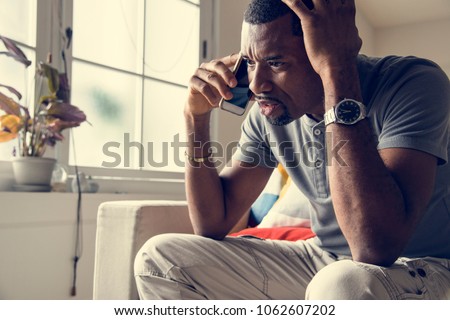 Black guy talking phone with angry emotion