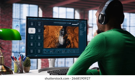 Black guy uses deep learning tools to generate video footage from text prompts in a productive home environment. Freelancer uses computer to display generative AI montage. Camera A.