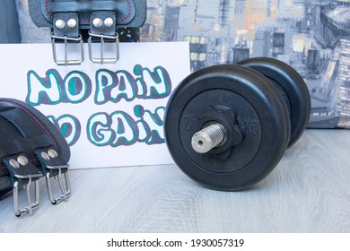 Black gym dumbbell, belts, kettlebell with motivational poster Train hard for active workouts at home. Home workouts, healthy lifestyle - Powered by Shutterstock