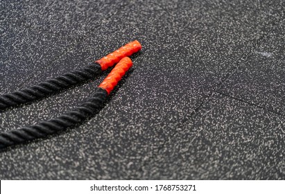 Black Gym Rope On The Rubber Floor Of The Training Area 