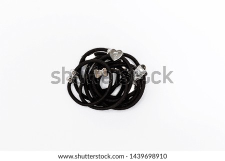 Black hair bands on white background