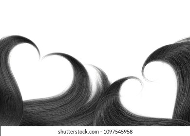 Black hair in shape of heart on white
