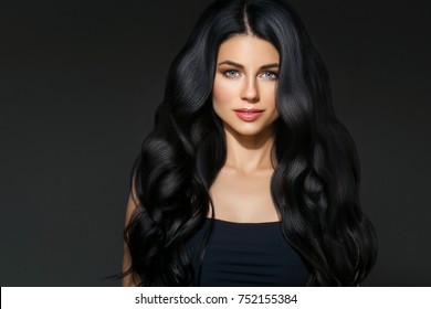 Black hair woman. Beautiful brunette hairstyle fashion portrait with beauty long black hair over dark background
