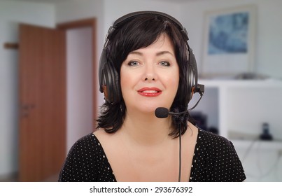 Black Haired Woman In Headset Working With E-learning Language Company. She Is Bilingual Teacher