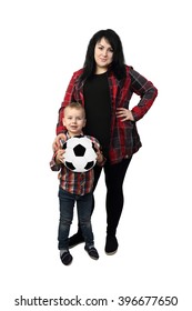 Black Haired Woman Stands Together With Small Boy Holding A Soccer Ball In Hands - Mother And Little Son Isolated On White Background