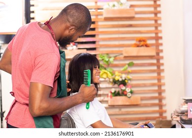 Black Hairstylist Working On A Lady's Hair