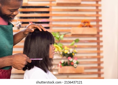 Black Hairstylist Working On A Lady's Hair