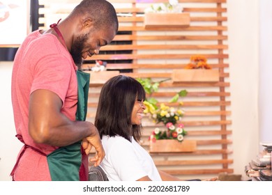 Black Hairstylist Working On A Lady's Hair