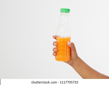 
Black Hand Holding A Bottle Of Juice Isolated On A White Background. Front View. Mock Up. Copy Space. Template. Blank.