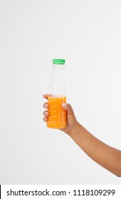 
Black Hand Holding A Bottle Of Juice Isolated On A White Background. Front View. Mock Up. Copy Space. Template. Blank.