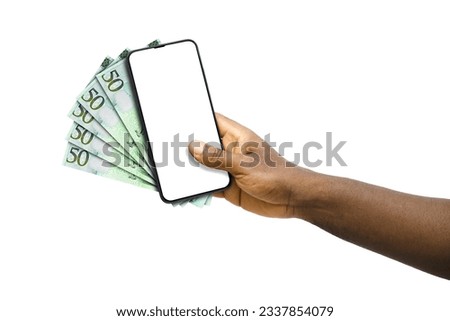 Black hand holding mobile phone with blank screen and Libyan dinar notes Сток-фото © 