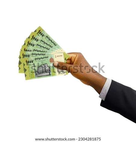 Black hand with suit holding 3D rendered Yemeni Rial notes isolated on white background