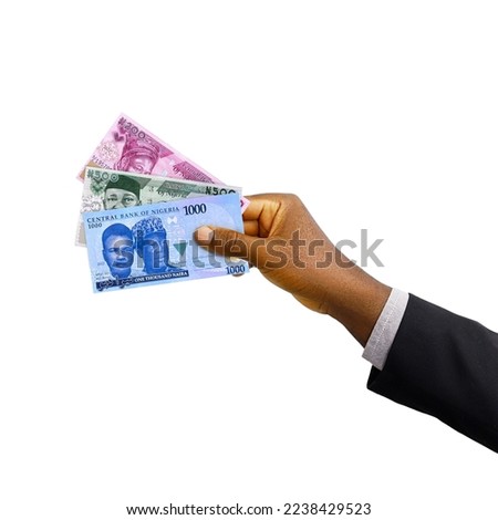 
Black hand with suit holding New Nigerian Naira notes isolated on white background, 3d rendering
