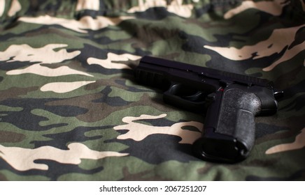 Black Handgun, Firearm On Camouflage Army Green Fabric