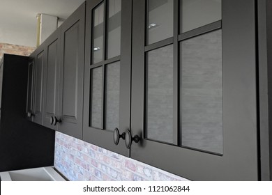 Black handles vintage style on black kitchen wooden cabinets  - Shutterstock ID 1121062844