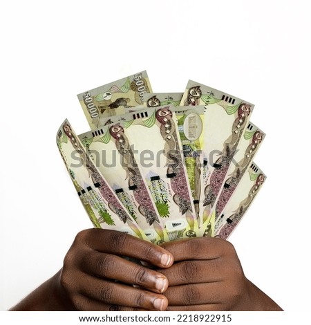 Black hands holding 3D rendered Iraqi dinar notes. closeup of Hands holding Iraqi currency notes Stock foto © 
