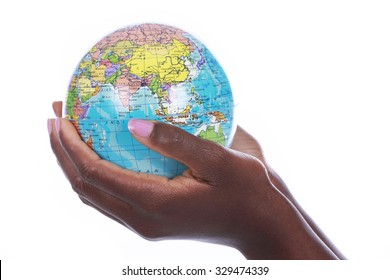 Black Hands Holding A World Globe Isolated On White