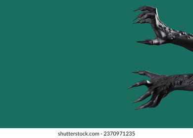 Black hands of witch with claws on green background. Halloween celebration