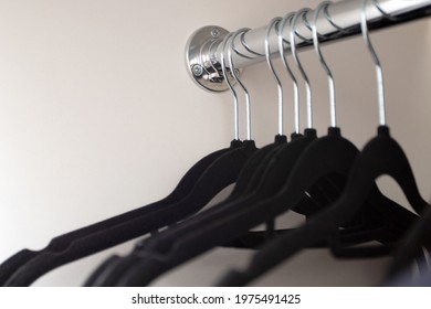 Black Hangers In The Closet. Hangers In The Cabinet On The Rod. Empty Wardrobe.