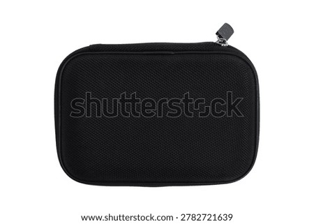 Black hard shell protective case isolated on white background. Small travel organizer pouch with zipper for electronic accessory, cable, or gear storage. Compact shockproof equipment container.