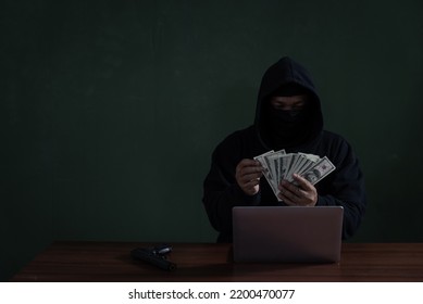 Black Hat Hacker Counting Banknote While Hacking Information Fro