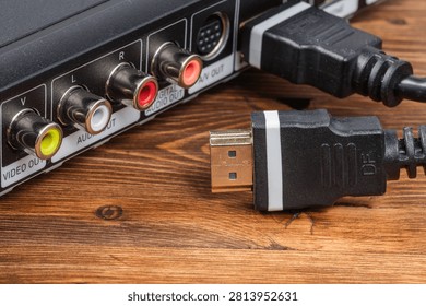 Black HDMI digital interface cable connector with a gold plated plug ready to be connected.