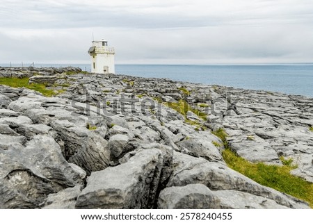 Black Head Lighthouse, situated in the rough rocky landscape of Burren, amidst a bizarre scenery of steep limestone mountains and rocky coastline, County Clare, Ireland.