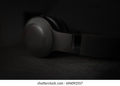 Black headphones on black dark background - Powered by Shutterstock