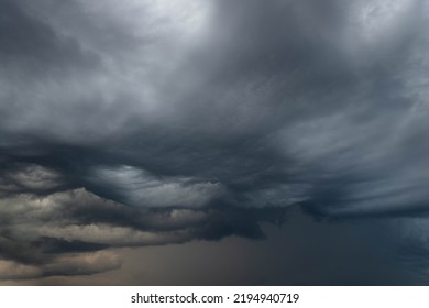 Black, heavy, undulating storm clouds. They are awe-inspiring, foreshadowing the arrival of sudden rains and life-threatening winds. - Shutterstock ID 2194940719