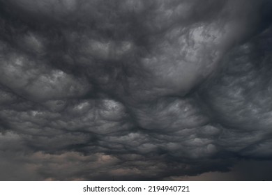 Black, heavy, undulating storm clouds. They are awe-inspiring, foreshadowing the arrival of sudden rains and life-threatening winds. - Shutterstock ID 2194940721